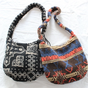 Detailed view of plush faux shearling crossbody bags with ethnic and paisley patterns