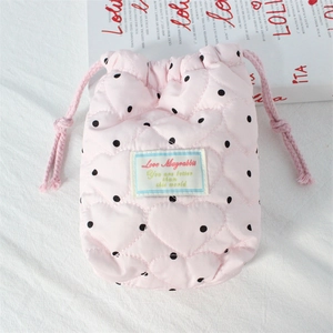 Pink heart-quilted drawstring camera pouch with black polka dots and woven label