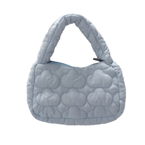 Light blue quilted puffer cloud handbag featuring a soft texture and zipper closure