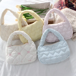 Detailed selection of quilted cotton handbags in pastel colors with heart patterns