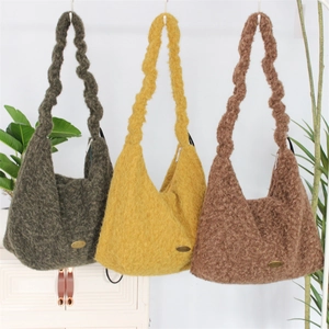 Detail of plush tote bags in green, yellow and brown with unique wavy shoulder straps