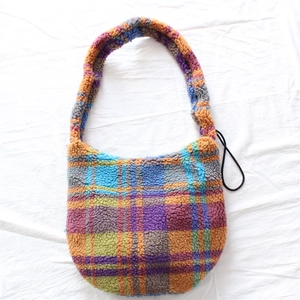 Detailed view of plush colorful plaid shoulder bag with soft fuzzy fabric texture