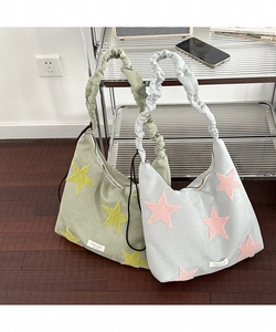 Detail of shoulder bags with star embroidery and unique ruched scrunchie-style straps