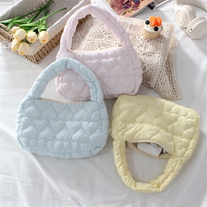 Pastel heart-quilted fabric handbags in pink, blue, and yellow with zip closure