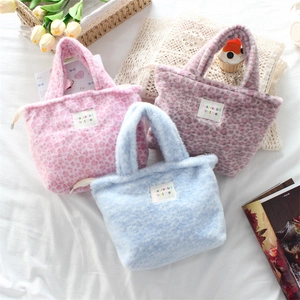 Three plush leopard heart pattern handbags in pink, blue, and purple displayed together