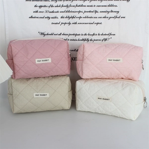 Quilted heart cosmetic bags in four pastel colors with metal zippers and fabric labels