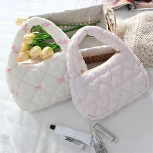 Quilted mini tote bags in white with pink bow and pink heart patterns on a floral backdrop