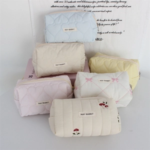 Quilted heart pattern makeup bags in assorted pastel colors and embroidered designs