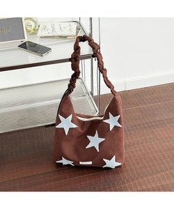 Detail of star embroidery and ruched adjustable strap on brown suede shoulder bag