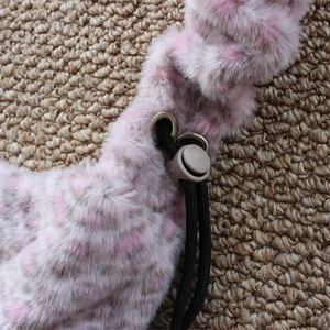 Macro detail of faux fur bag texture with adjustable black drawstring and plastic toggle