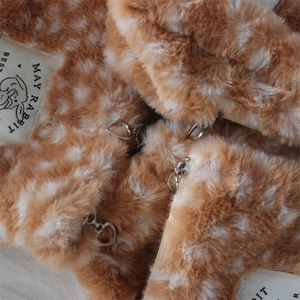Detail of plush fawn pattern bag with soft faux fur texture and silver heart zipper pull