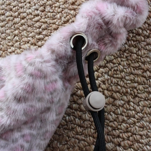 Detailed close-up of pink and grey leopard faux fur texture with black nylon drawstring