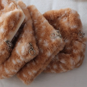 Detail of deer pattern faux fur bag showing soft texture and heart-shaped zipper pull