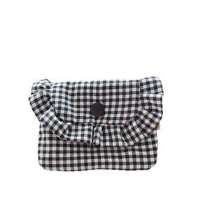 Mini gingham ruffle flap bag in black and white check with a black button closure