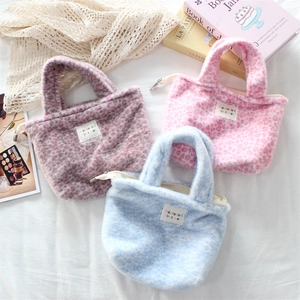 Detailed view of plush leopard print handbags in pink, blue, and purple soft faux fur