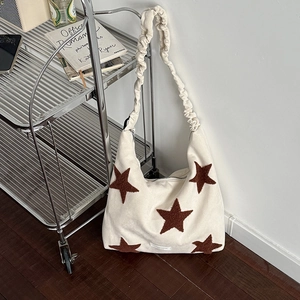 Star embroidered off-white canvas tote bag with adjustable ruffled cloud shoulder strap