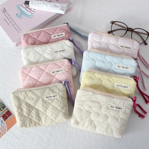 Quilted mini pouches in pastel colors with heart patterns and woven zipper pulls