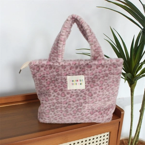 Close-up of pink leopard plush tote showing the soft faux fur texture and cloth label