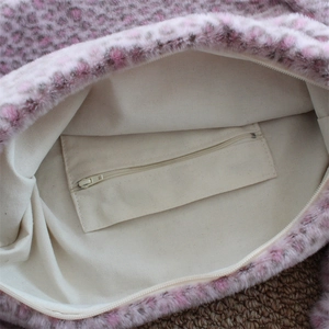 Detail view of pink leopard faux fur tote showing canvas lining and inner zipper pocket