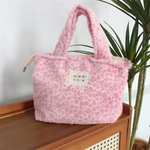 Detailed view of pink leopard plush handbag featuring zipper and mayrabbit fabric label