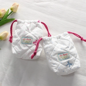 Close-up of quilted cotton camera pouches with polka dots and drawstring closure