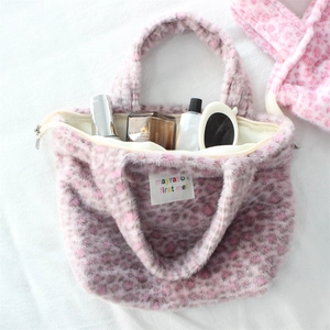 Macro view of plush leopard print storage bag interior with zipper and makeup items