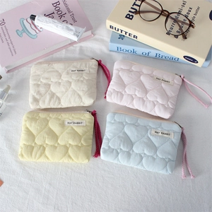Quilted heart pattern mini cosmetic bags in four pastel colors with zip closure