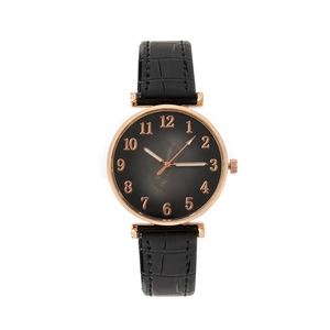 Detail of rose gold watch case with black crocodile embossed strap and leaf pattern dial