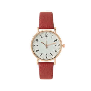 Women's quartz watch with red leather strap and rose gold case on white background