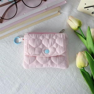 Detailed view of pink quilted heart pouch with snap button and side metal hook