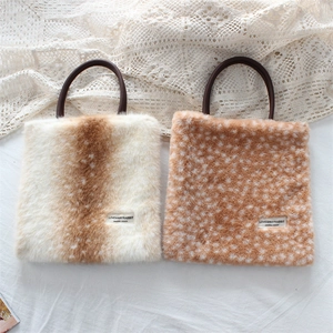 Detail of faux fur handbags with deer and animal patterns and circular handles