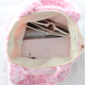 Top view of plush leopard print bag showing internal storage for phone and sunglasses