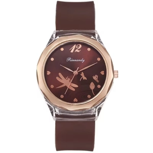 Detailed view of women quartz watch with butterfly dial and brown silicone strap