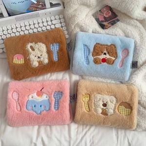 Detailed view of plush cartoon laptop sleeves in coffee, blue, pink, and cream colors