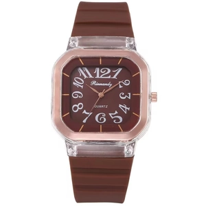 Close-up of square quartz watch with brown silicone strap and transparent rose gold case