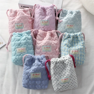 Quilted cotton camera storage pouches in various patterns with a soft drawstring closure