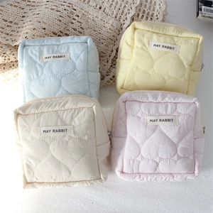 Cute heart quilted makeup bags in light blue, yellow, white and pink with zip closure