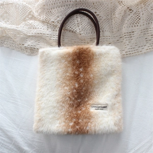 Close-up of plush faux fur handbag featuring deer pattern and brown circular handle