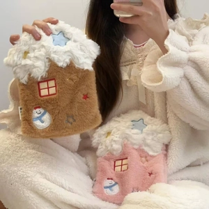 Plush star house hot water bags in brown and pink shown in cozy indoor setting