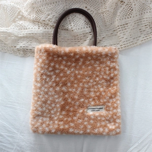 Close-up of plush fawn print handbag with dark brown rounded handle and soft fur texture