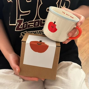 Ceramic coffee mug with red apple print and gift box, minimalist cream aesthetic