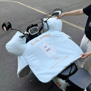 Detail of light blue electric scooter leg cover featuring a cute cartoon puppy design