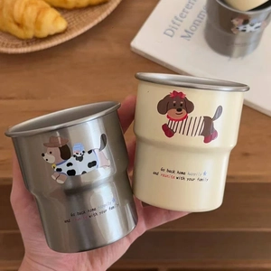 Close-up of stackable dachshund mugs in stainless steel and cream with cute dog prints