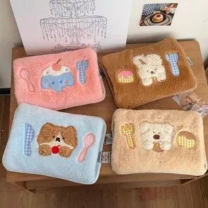 Detail of plush electric hot water bags with cute animal embroidery on soft faux fur