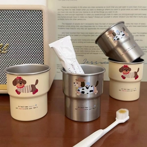 Detail of four stainless steel mugs with cartoon dachshund prints and cream finish