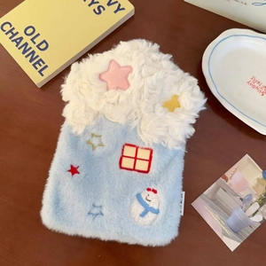 Detail of blue plush hot water bottle cover with embroidered stars and snowman motif