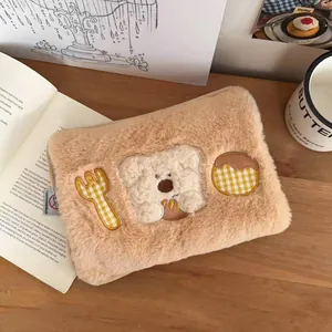 Detail of plush cartoon hot water bag with teddy bear embroidery and fuzzy texture