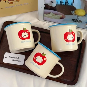 Macro detail of cute cartoon ceramic mugs with apple cat design on a wooden tray