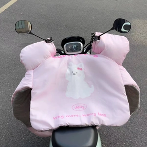 Detail of pink waterproof handlebar muffs with thick plush lining and cartoon dog print