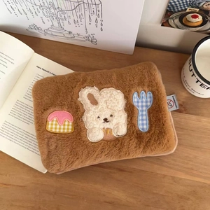 Close-up of brown plush electric hot water bottle cover with cute puppy embroidery